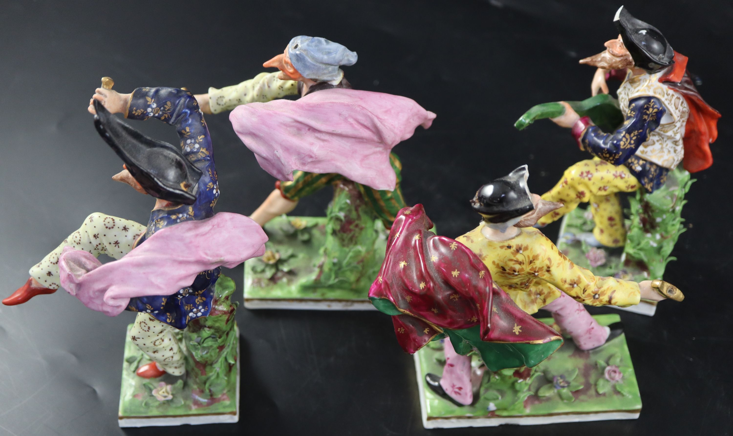 A set of four Continental porcelain Derby-style Comedia del Arte figures, largest 18.5cm